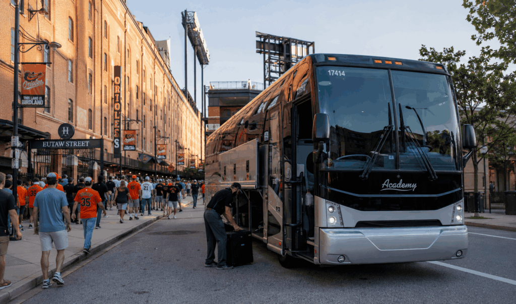 luxury charter bus dropping off orioles fans at camden yards in baltimore for a game day trip from alexandria virginia