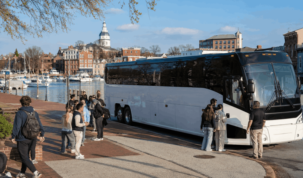 charter bus parked near annapolis harbor for a naval academy group trip