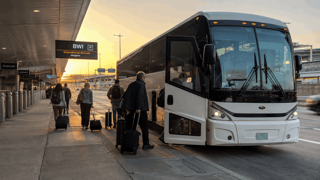 charter bus dropping off group travelers at bwi airport from alexandria