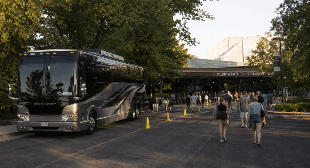 luxury charter bus arriving at merriweather post pavilion in columbia md before a summer concert.