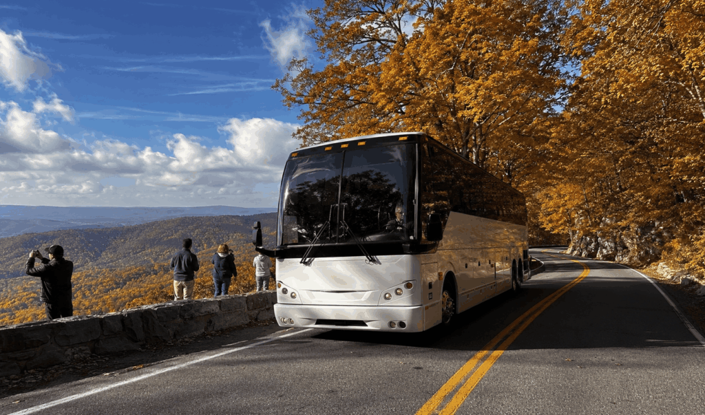 luxury charter bus traveling along skyline drive in shenandoah national park during fall foliage near luray virginia