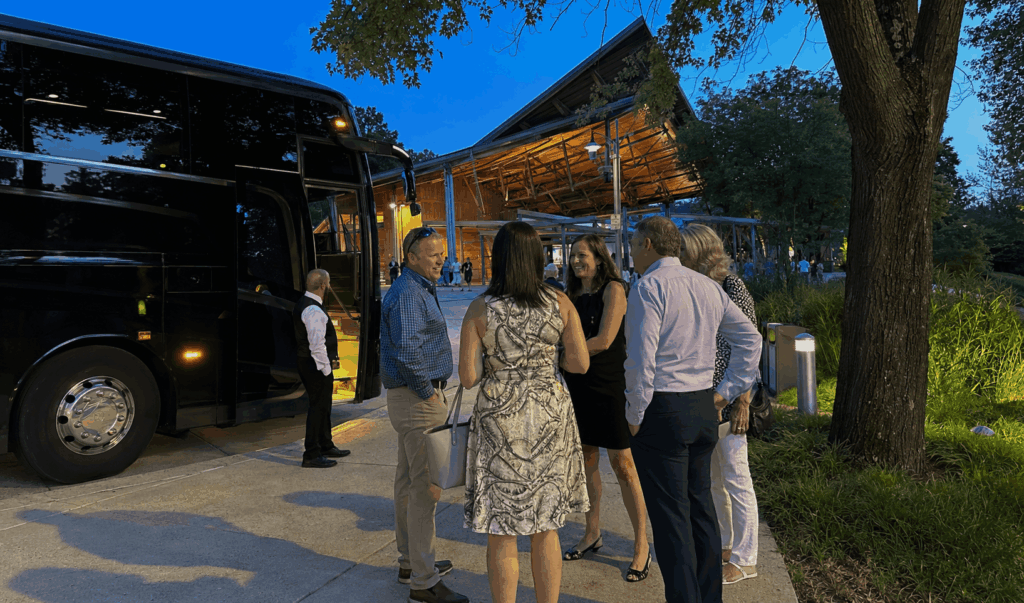 friends arriving at wolf trap filene center by charter bus for an outdoor concert near alexandria virginia